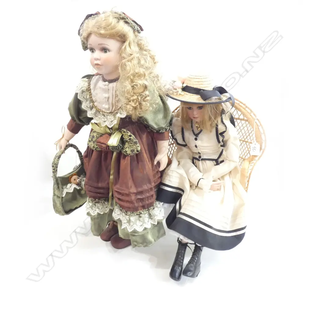 TWO PORCELAIN DOLLS; 1 W STAND (H. 670MM) & 1 SITTING IN CANE CHAIR (H. 485MM) Image 1++