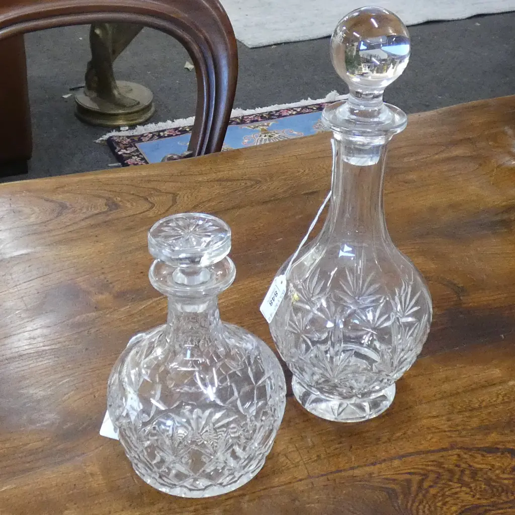TWO CUT GLASS DECANTERS; H. 330 & 200MM  (1 STOPPER HAS SOME CHIPPING AROUND THE END) Image 1++