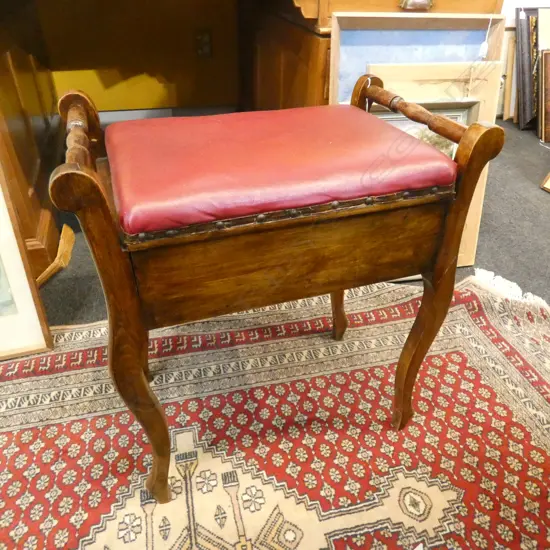 OLD WOOD & RED LEATHER (?) PIANO STOOL - W PIANO BOOKS UNDER SEAT 
