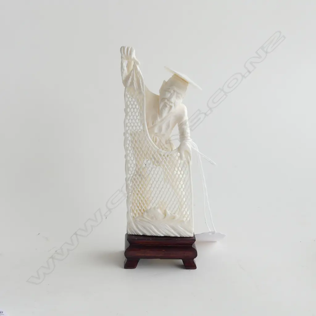 CARVED IVORY ORIENTAL FISHERMAN WITH NET, ON WOODEN STAND, H. 150MM Image 1++