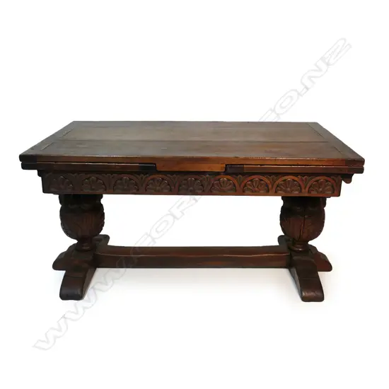 A Victorian oak Elizabethan style refectory draw leaf dining table