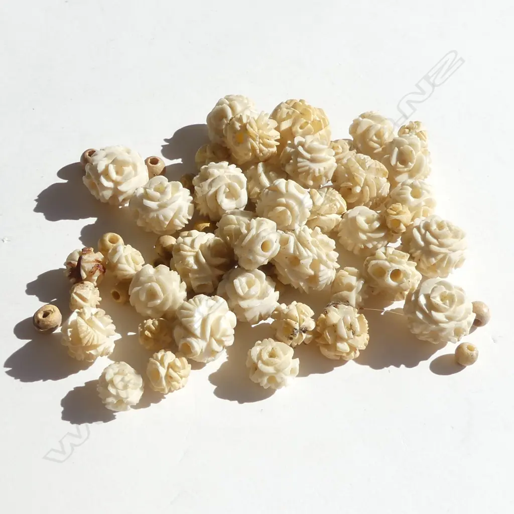 SMALL BAG ASSORTED FLORAL CARVED IVORY BEADS Image 1++