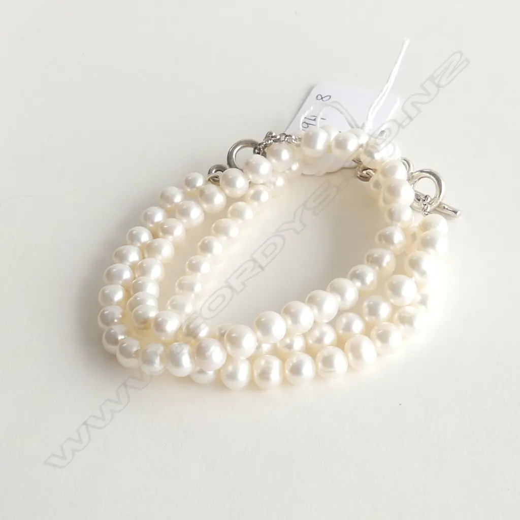 THREE FRESH WATER PEARL AND SILVER BRACELETS Image 1++