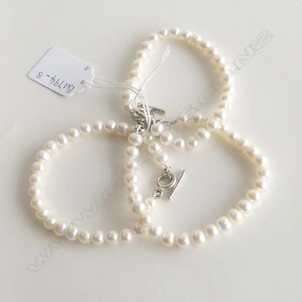 THREE FRESH WATER PEARL AND SILVER BRACELETS Image 1++