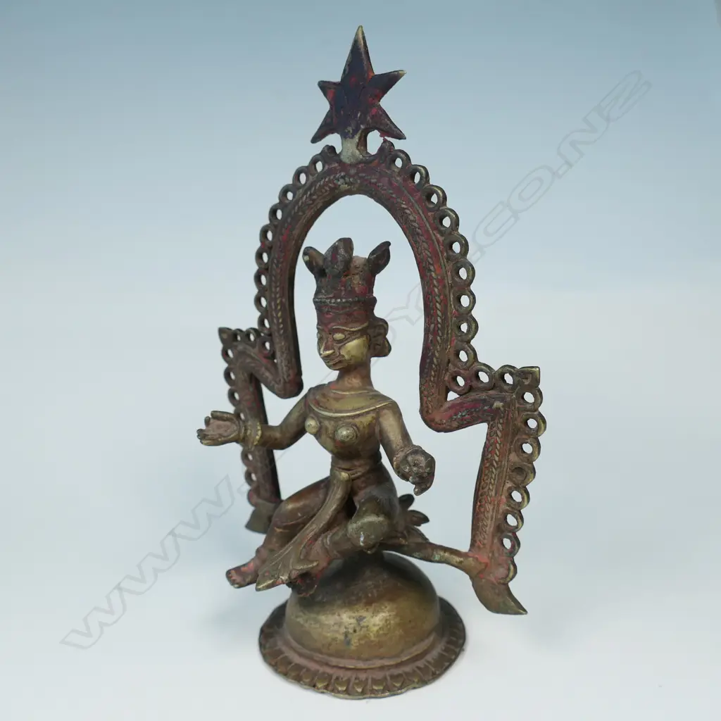 AN INDIAN BRONZE STATUETTE, A FIGURE WITH HANDS IN GYAN MUDRA SEATED BENEATH AN ARCH, ON DOMED PLINTH BASE… Image 1++