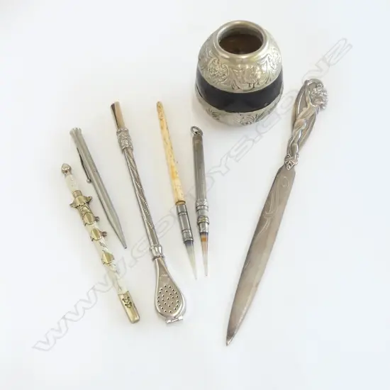 An Argentinian marte gourd and bombilla straw, along with five interesting letter openers and pens,