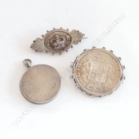 A Victorian sterling silver Crown brooch, a Queen Victoria 1887 Jubilee brooch and a Prince of Wales Investiture locket,