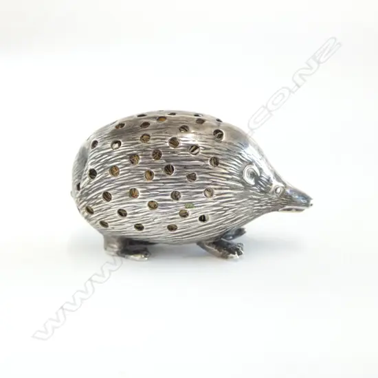 A small sterling silver porcupine pin cushion,