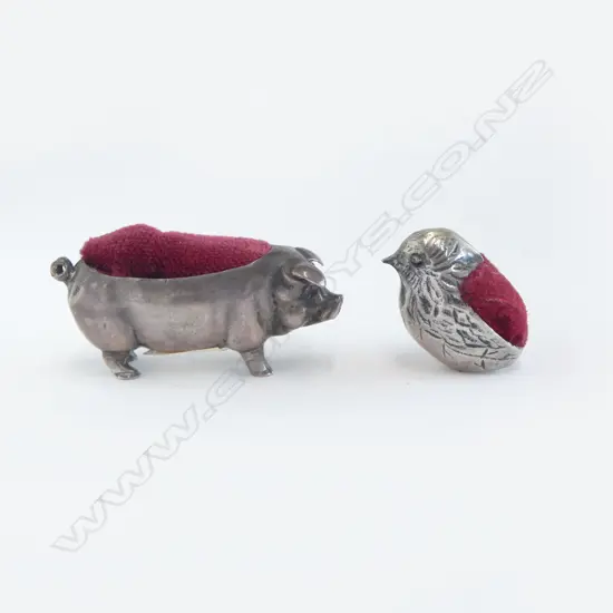 Two miniature silver pin cushions,