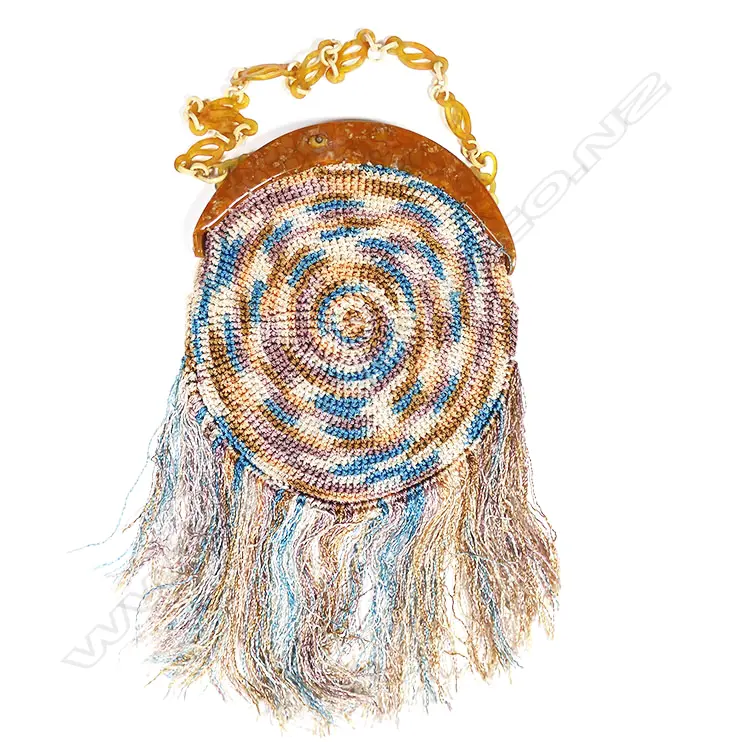 A French Art Deco period crocheted silk handbag with mottled amber plastic frame, Image 1++