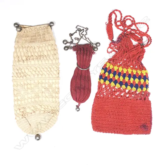 A colonial string work purse in plum red, and another in cream, with dumbbell frames, with another in bright cottons