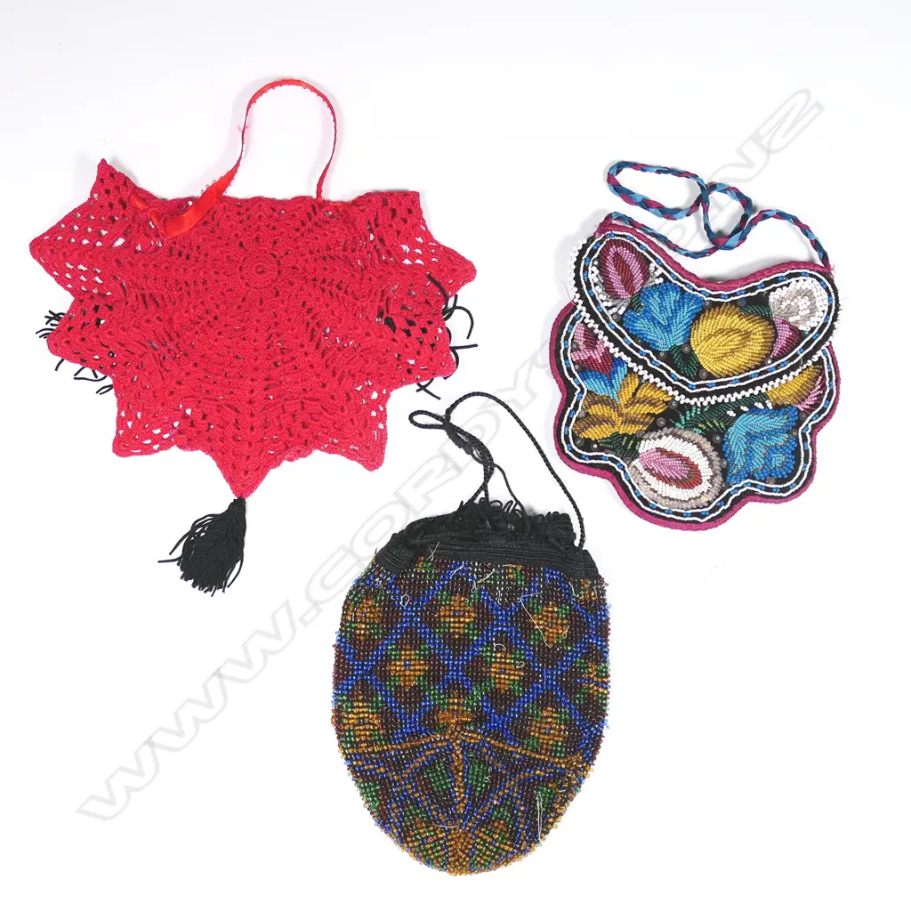 A Victorian black velvet beaded handbag, a beaded reticule and a 1930s raspberry red crocheted cotton spider's web handbag. Image 1++