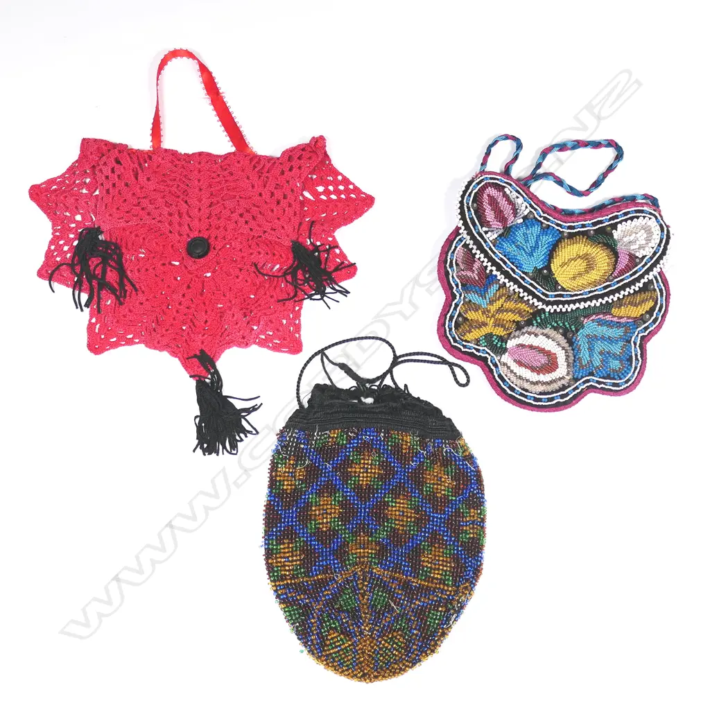 A Victorian black velvet beaded handbag, a beaded reticule and a 1930s raspberry red crocheted cotton spider's web handbag. Image 1++