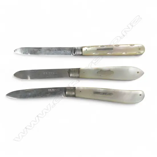 Three mother of pearl handled folding sterling silver bladed fruit knives, various dates and makers.