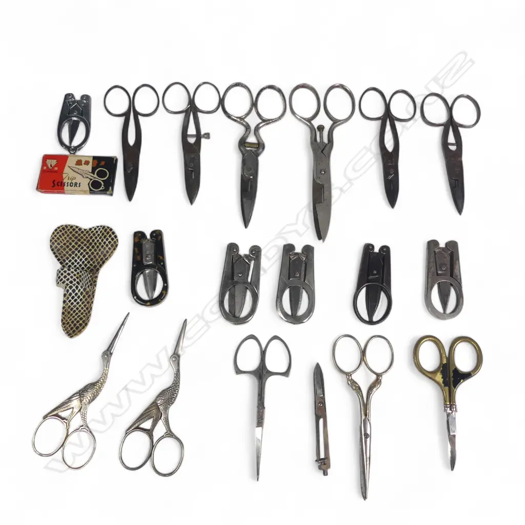 A box of various small sewing scissors, folding handle trip scissors and two 'stork' scissors. Image 1++