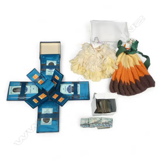 Two china half-doll mounted tea cosies, a novelty drop side box of Abel Morrell's needles, and an incomplete set of WWI period Battleship game markers