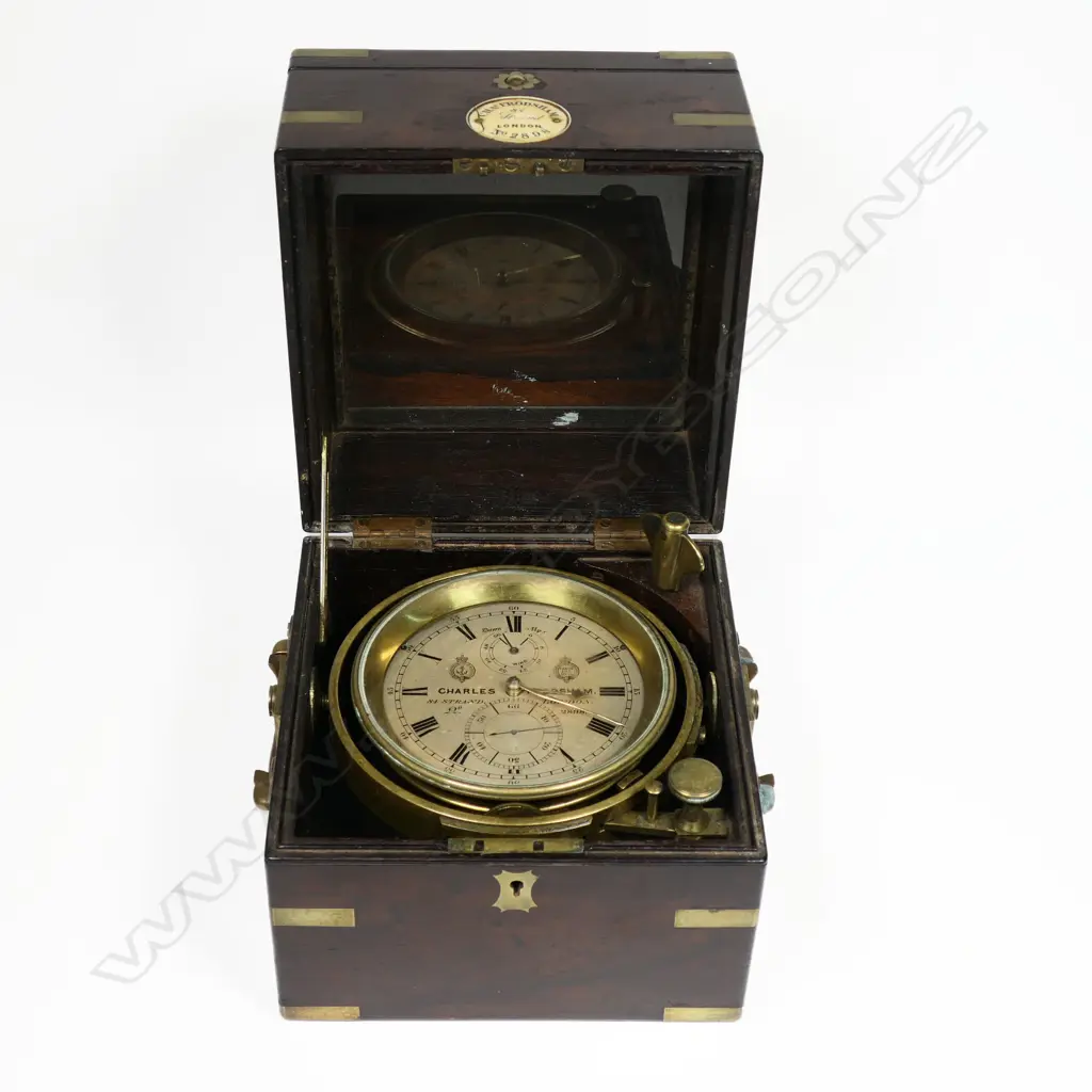 A 19thC two-day marine chronometer by Charles Frodsham, 84 Strand London, No.2898, c.1858, running, in dark mahogany three-piece case with brass capping and binding and folding carry handles. Image 1++