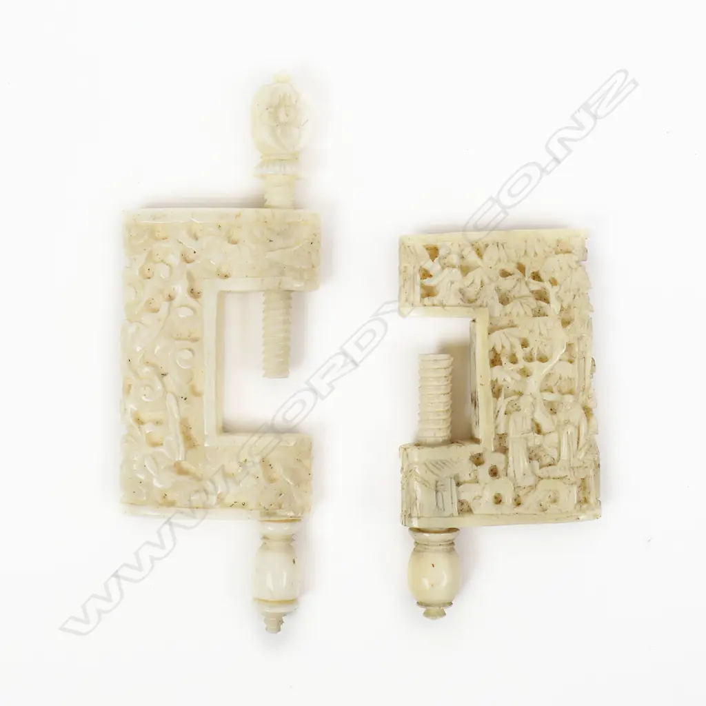 Two Chinese carved ivory sewing work clamps, one carved with flowers, the other with figures in a landscape. Body H.40mm Image 1++