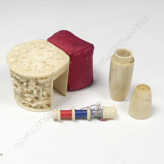 A large Chinese carved ivory sewing clamp and an ivorine bobbin case,