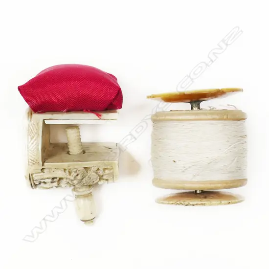 A Chinese carved ivory sewing clamp with a bone and mother of pearl bobbin spool,