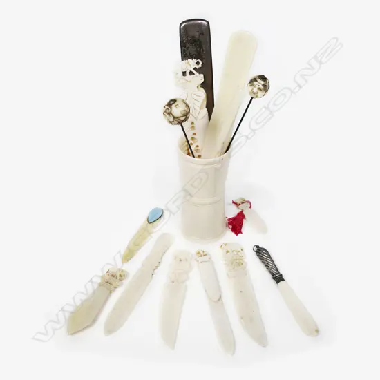 An Ivory dice cup containing a selection of letter knives, hat pins, etc,
