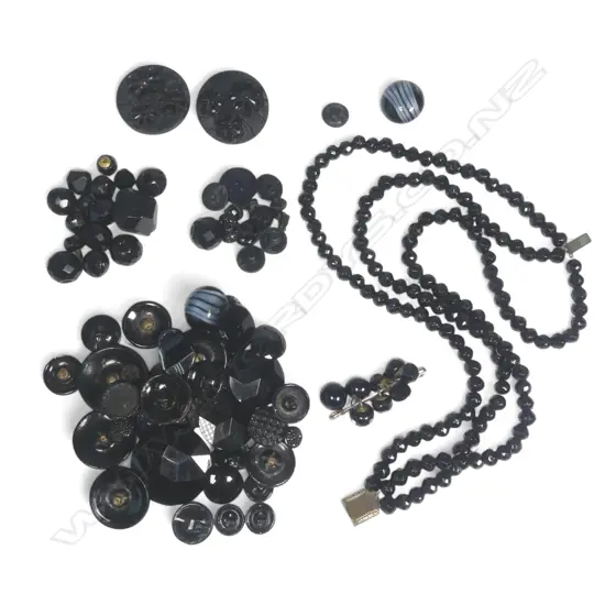 A collection of various black buttons and beads