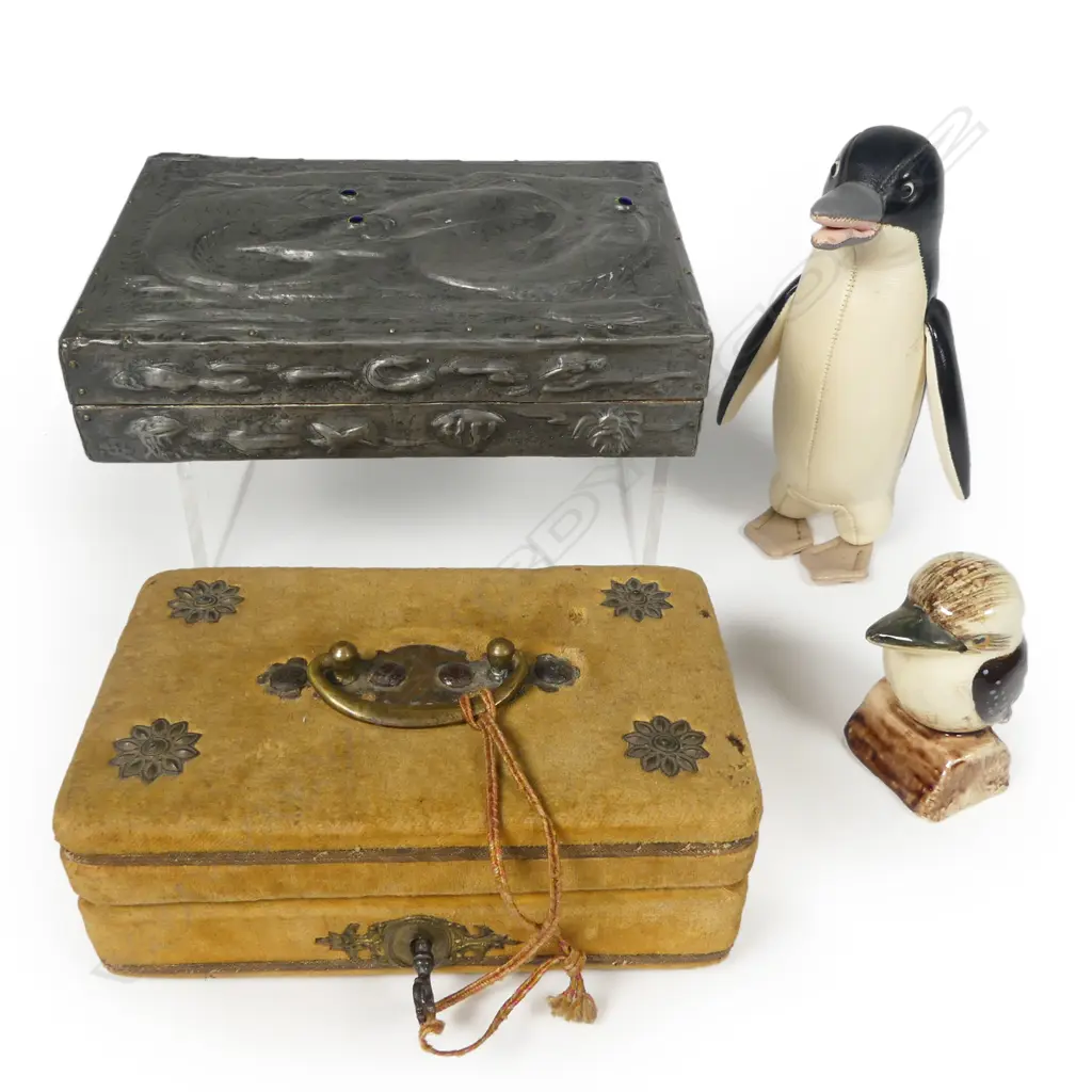 An embossed pewter Arts & Crafts style cigarette box; a microscopically inscribed grain of rice curio; a Japanese Tomi leather penguin and a Grace Seecombe kookaburra salt shaker. Image 1++