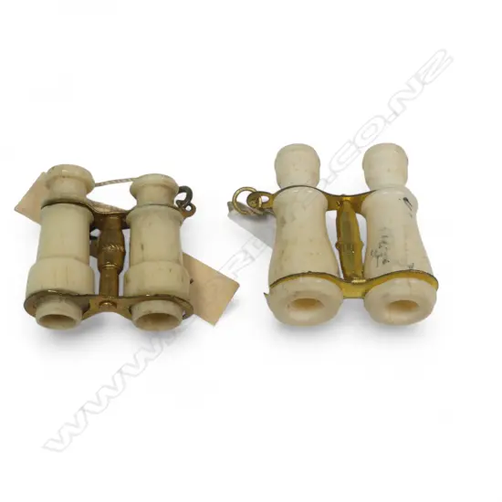 Two miniature bone and gilt metal Stanhopes binoculars, one of the Dunedin Expo, the other Selworth.