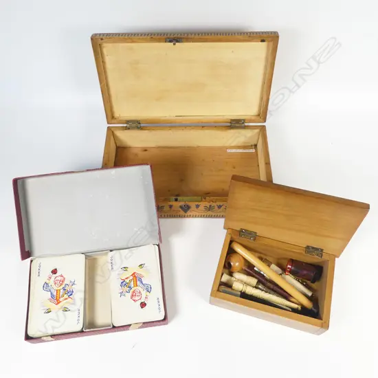 Small wooden box containing cigar piercers, bone cigarette holders and risqué monocular viewer. With a pen-work decorated box and set of Thomas de la Rue 'Pneumatic' playing cards