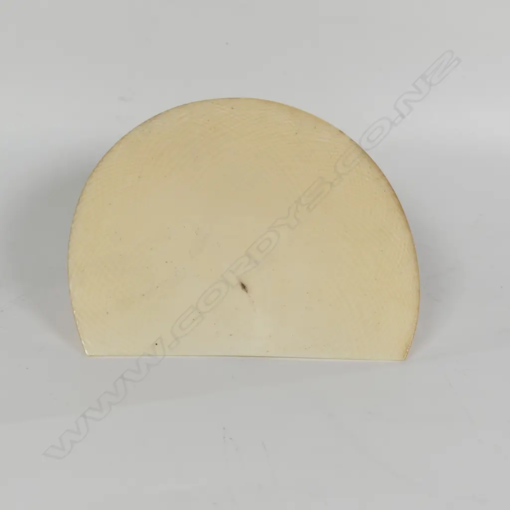 A racially caricaturing carved ivory and ebony figure of a black girl seated with a dinner plate carrying a single large cricket insect Image 1++