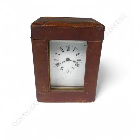 A French brass cased carriage clock in leather travel case,