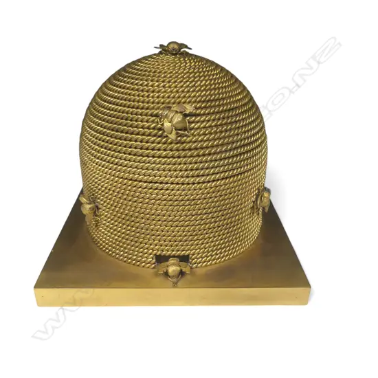 A good mid-Victorian George Betjemann & Sons gilt-metal bee skep sewing box, of classic beehive shape of straw rope twist, surmounted by bees, on a square plinth base with recessed feet.