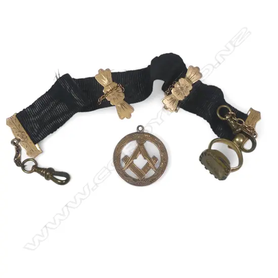 A 9ct gold Masonic medallion fob and a black silk Leontine with 9ct gold mounts, gold plated dog clip and intaglio jewel seal