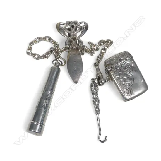 Art Nouveau silver plate double chain chatelaine with sterling silver seal button hook, small vesta and case containing an amber and silver cigarette holder.
