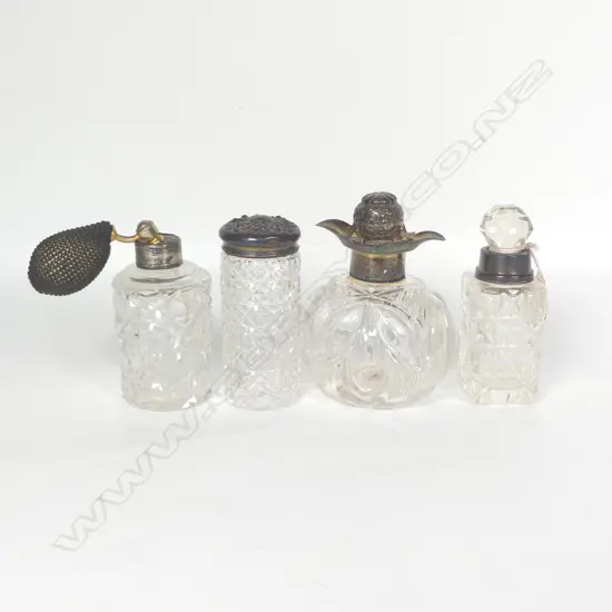 Four cut crystal dressing table bottles with silver mounts, some faults.