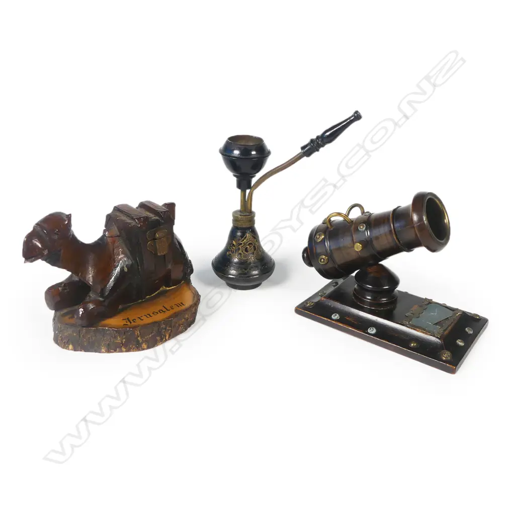 A novelty vesta modelled as a mortar cannon, a small brass hookah pipe, and a carved olive wood camel souvenir of Jerusalem whose saddle opens to reveal a small inkwell. Camel L.120mm Image 1++