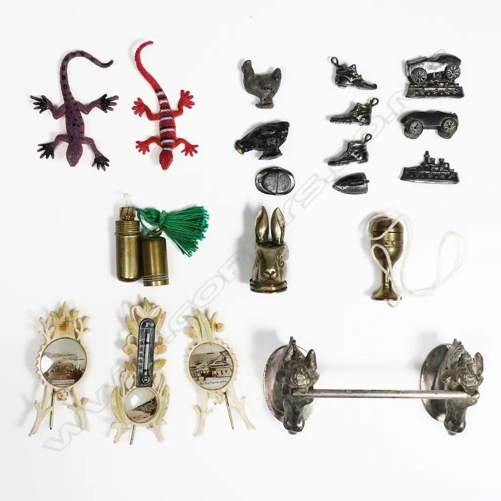11 lead monopoly game markers; a cup and acorn catch game; horse head knife rest and miscellaneous souvenir pieces, etc. Image 1++