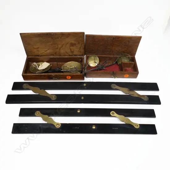 Two ebony and brass parallel rules, with two small boxed portable balance scales.