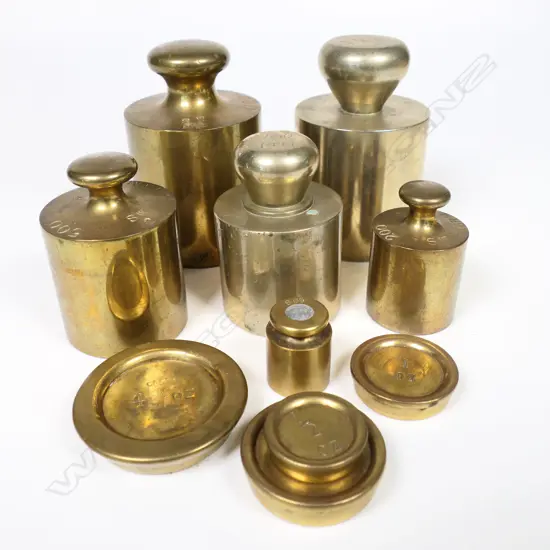 A mixed set of metric cylinder weights and four pan weights 1/2 oz to 4 oz.