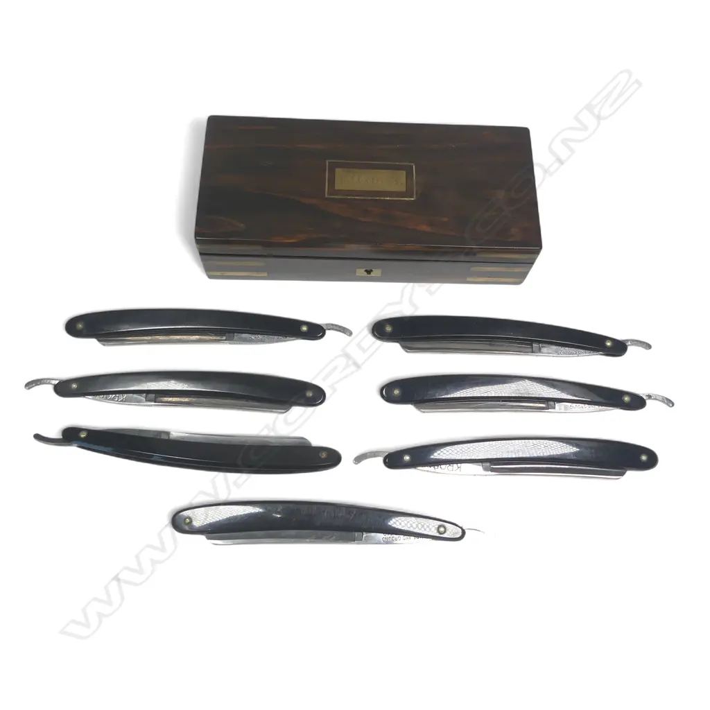 A set of seven Kropp cut throat razors, the blade spines etched with days of the week, in fine rosewood presentation case with brass corner strapping and escutcheon to the hinged lid, Image 1++