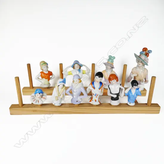 A collection of ten porcelain half-dolls, of various sizes, the largest with faults.