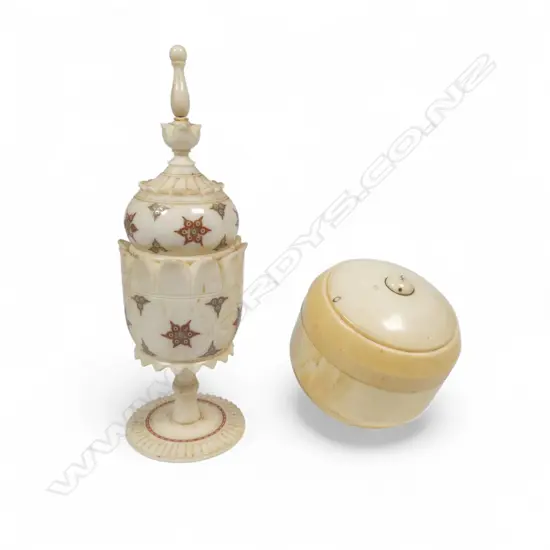 A turned solid ivory two-piece box of rounded shape, and an Indian turned bone urn on pedestal foot decorated with coloured circle cut designs. H.140mm