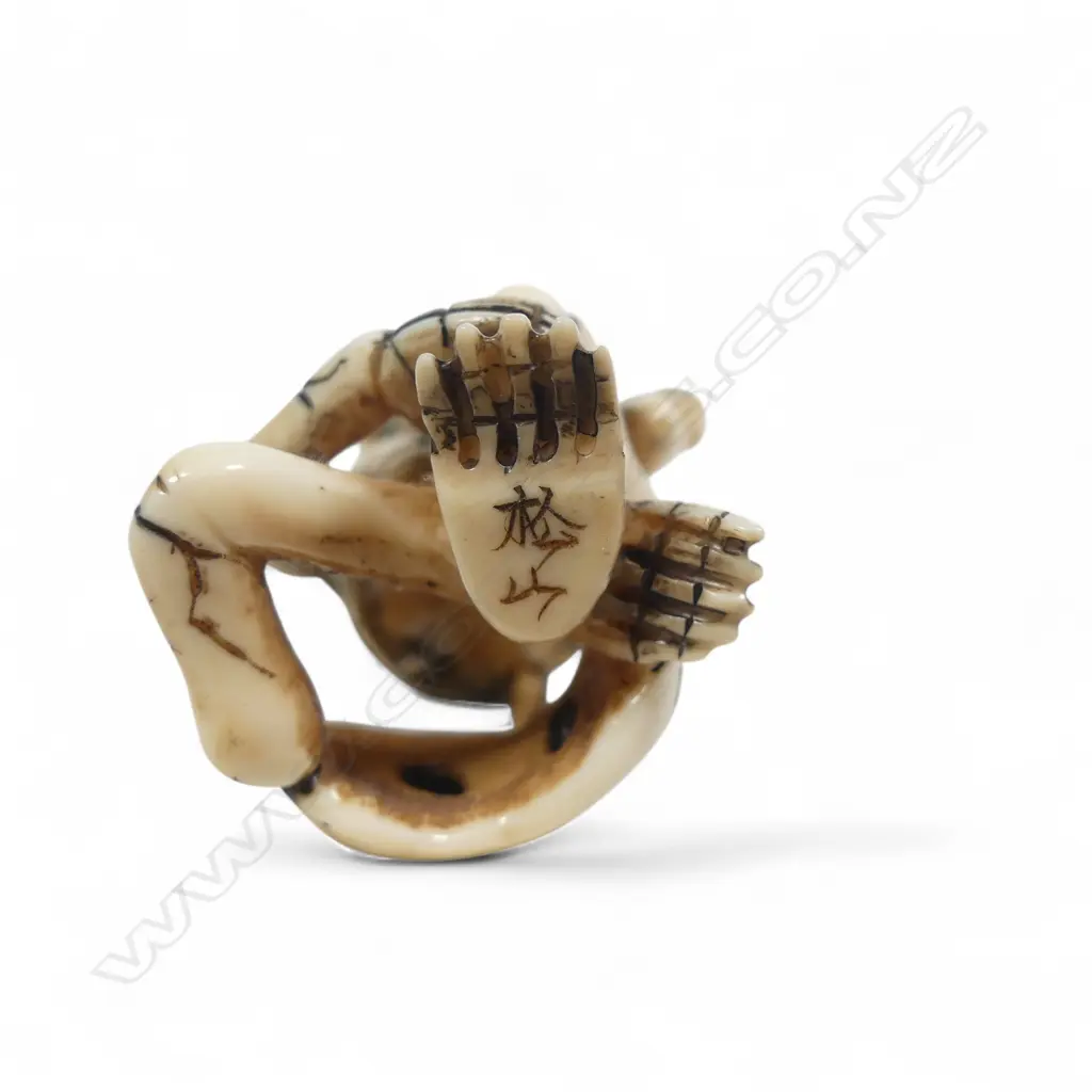 Japanese ivory netsuke of a skeleton, humorously rendered sitting cross-legged with one hand to his skull the other clasping his ankle,  signed to the foot 'Matsuyama'. H.55mm Image 1++