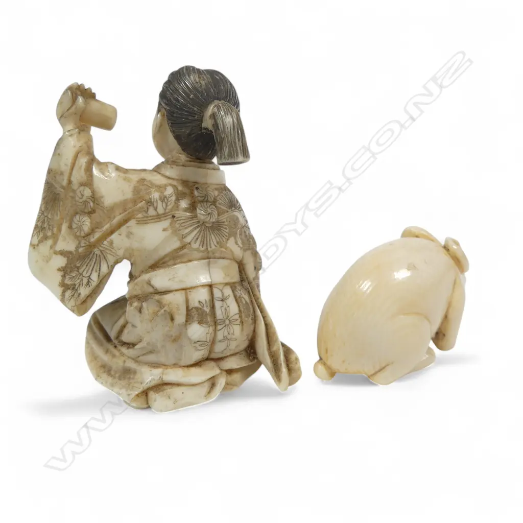 Two Japanese ivory carvings - a small okimono of a samurai kneeling whilst proffering a scroll (some losses), and a compact netsuke of a crouching rabbit. Image 1++