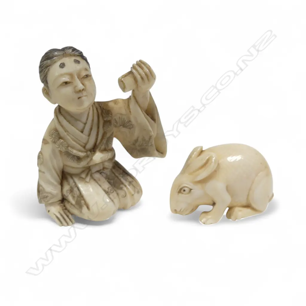 Two Japanese ivory carvings - a small okimono of a samurai kneeling whilst proffering a scroll (some losses), and a compact netsuke of a crouching rabbit. Image 1++