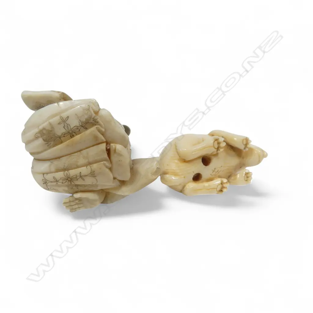 Two Japanese ivory carvings - a small okimono of a samurai kneeling whilst proffering a scroll (some losses), and a compact netsuke of a crouching rabbit. Image 1++