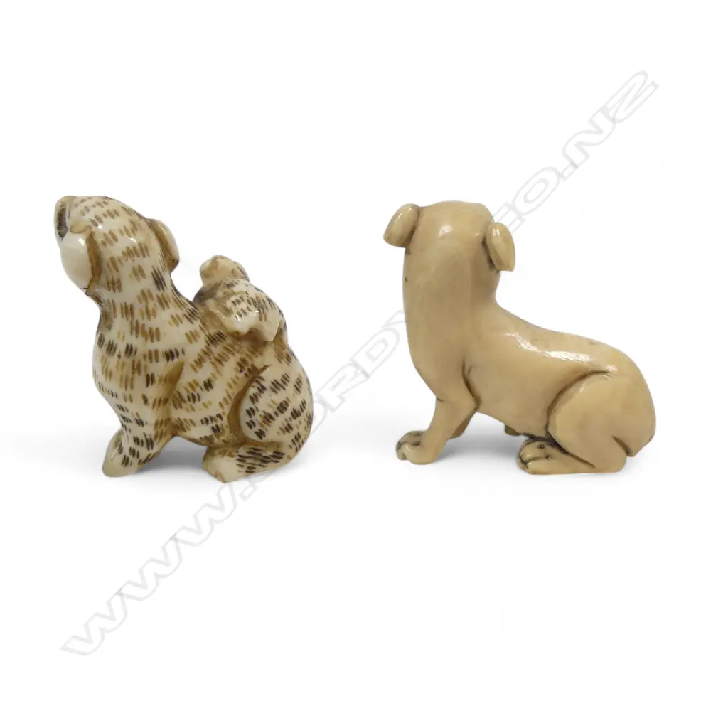 Two small Japanese ivory netsuke - a spotted dog with pup climbing its haunches; and a seated dog. Image 1++