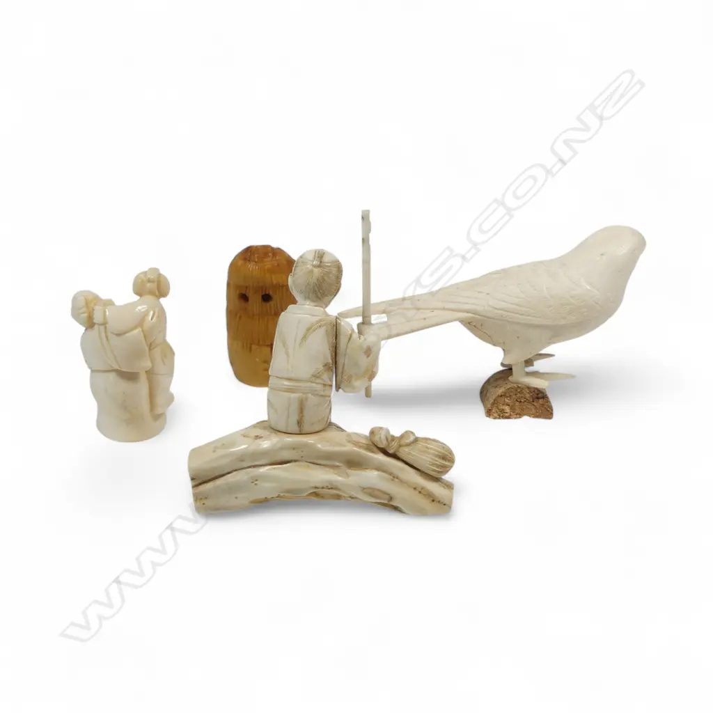 A sectional ivory okimono of a swallow, (nerve hollowed out and one end unplugged); a sectional okimono of a man with tame bird (detail absent from pole in right hand); ivory kimono of a couple and a tumeric stained tooth ivory netsuke. Image 1++