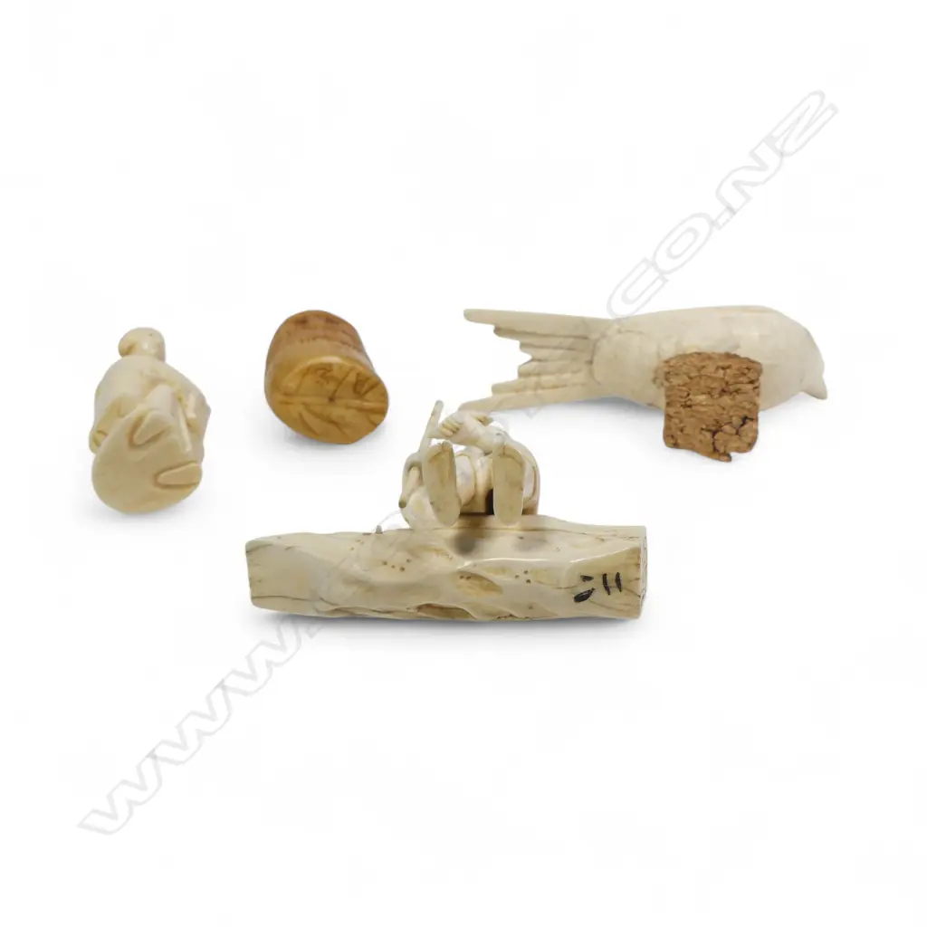 A sectional ivory okimono of a swallow, (nerve hollowed out and one end unplugged); a sectional okimono of a man with tame bird (detail absent from pole in right hand); ivory kimono of a couple and a tumeric stained tooth ivory netsuke. Image 1++