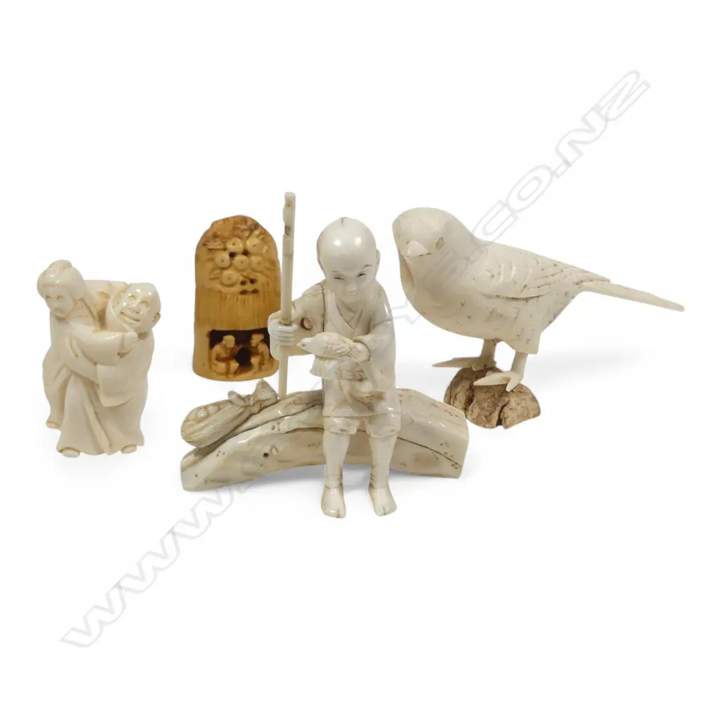 A sectional ivory okimono of a swallow, (nerve hollowed out and one end unplugged); a sectional okimono of a man with tame bird (detail absent from pole in right hand); ivory kimono of a couple and a tumeric stained tooth ivory netsuke. Image 1++